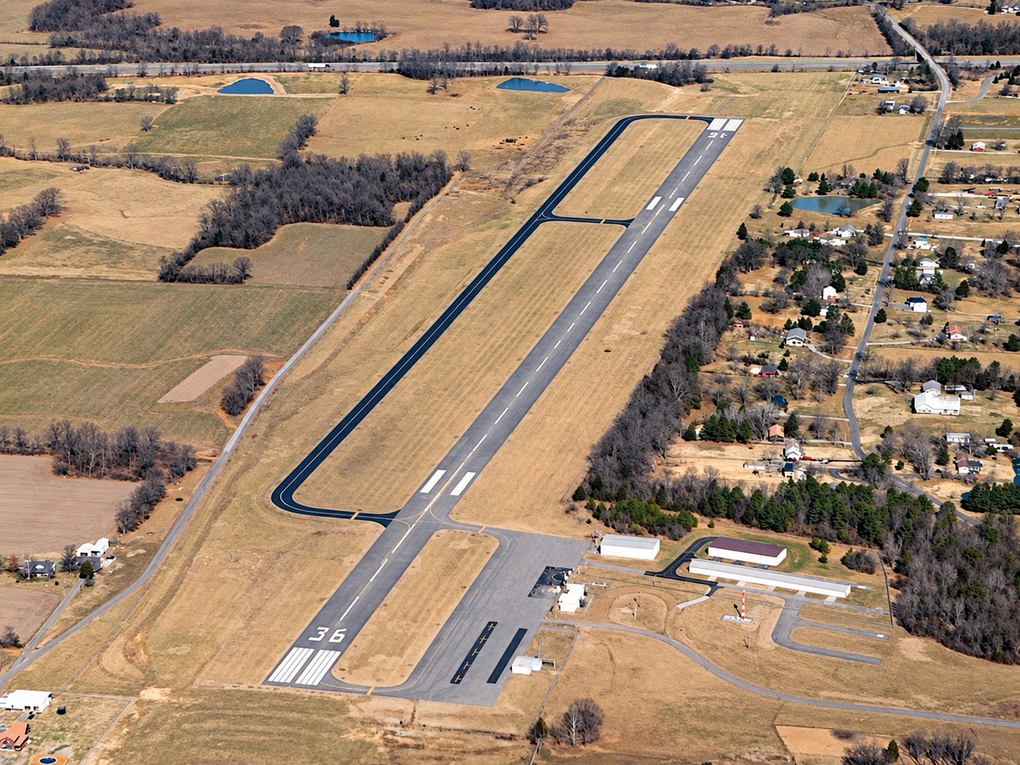 Historical aerial view of the airport runway, terminal and hangars